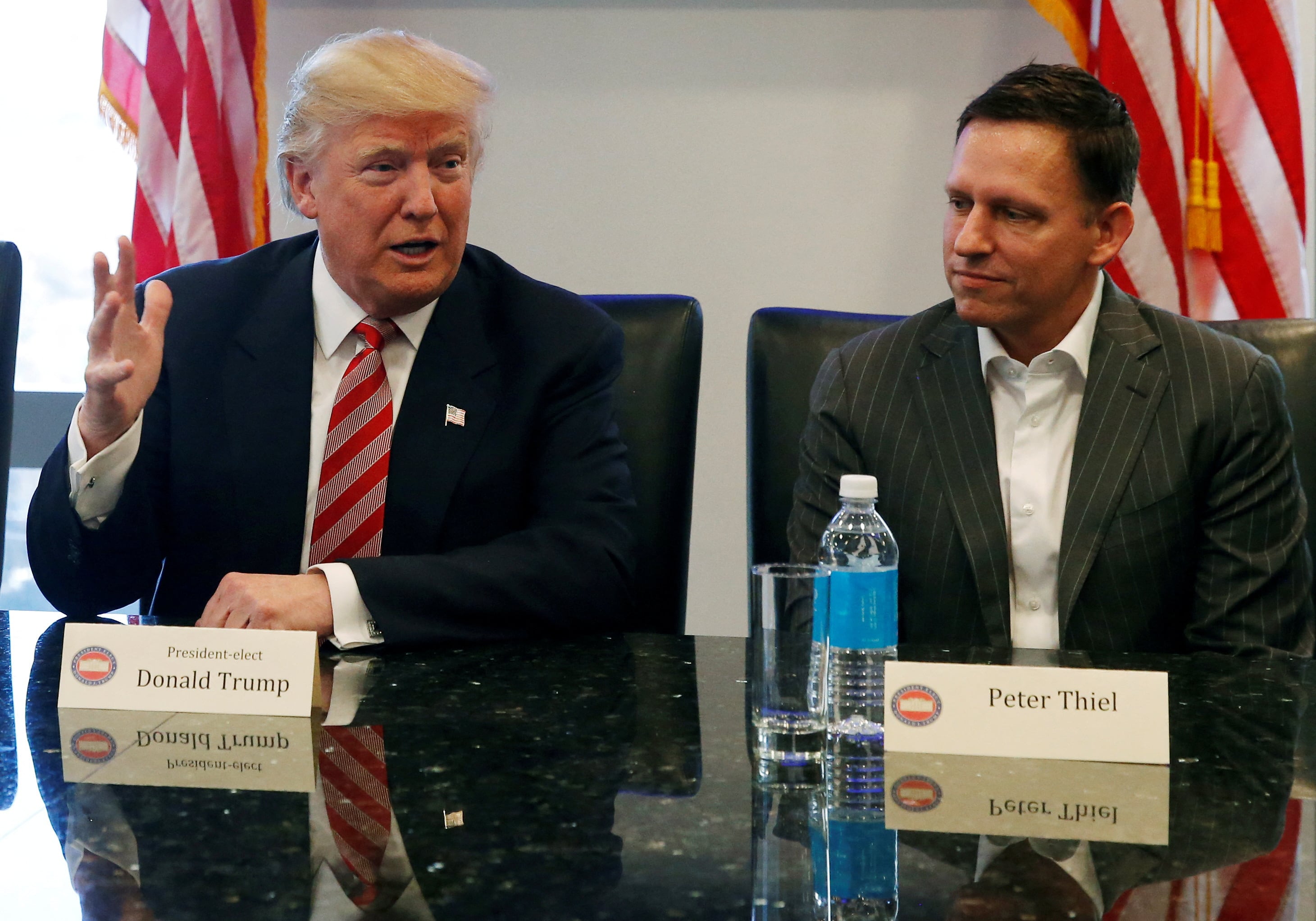 FILE PHOTO: U.S. President-elect Donald Trump sits with PayPal co-founder and Facebook board member Peter Thiel, during a meeting with technology leaders at Trump Tower in New York U.S., December 14, 2016. REUTERS/Shannon Stapleton/File Photo