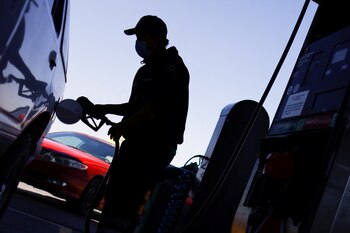 A worker fills a car