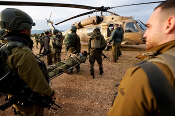 Israeli soldiers stand near a