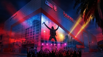Edificio con letreros de Futurama y Gustavo A. Madero, una gran fachada de cristal iluminada con la silueta de un músico y espectadores.