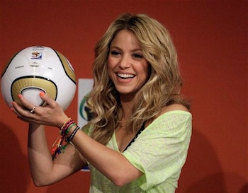 Shakira holds a ball that