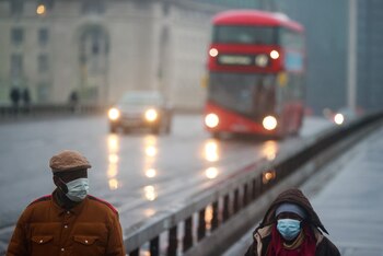 People wearing face masks walk