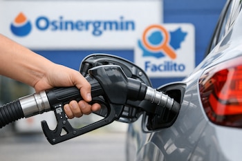 Primer plano de una mano sosteniendo una manguera de combustible negra, insertada en el tanque de un auto gris. Al fondo borroso, logos azules de Osinergmin y Facilito.