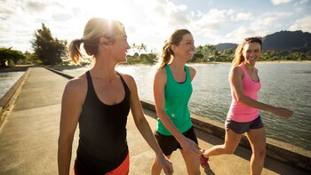 A group of friends walking a scenic pier in Hawaii