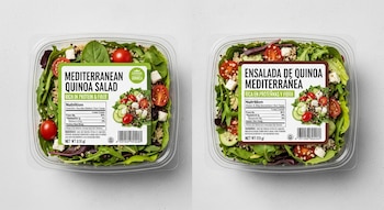 Dos envases de plástico transparente que contienen ensalada de quinoa, tomate, pepino, queso y hojas verdes. Cada envase tiene una etiqueta.