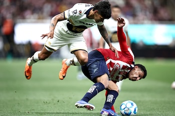 Pumas' Paraguayan forward #31 Robert Morales (L) and Guadalajara's defender #05 Bryan Gonzalez (R) fight for the ball during the Liga MX Clausura football match between Guadalajara and Pumas at Akron stadium in Zapopan, Jalisco state, Mexico, on April 5, 2026. (Photo by Ulises Ruiz / AFP)