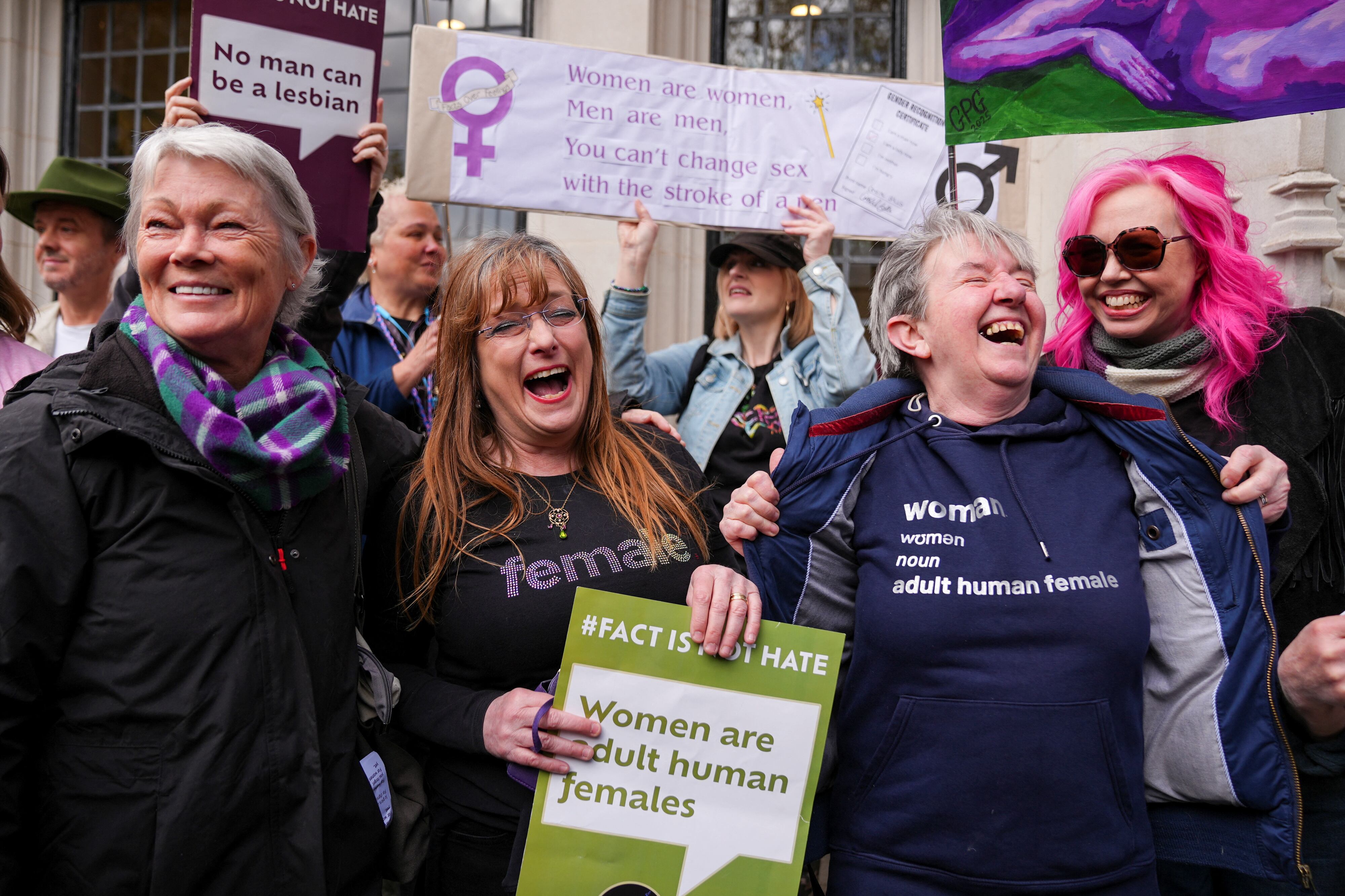 People celebrate, as the Supreme Court rules on an appeal by For Women Scotland about whether a person with a full gender recognition certificate which recognises that their gender is female is a woman under British equality laws, outside the Supreme Court in London, Britain, April 16, 2025. REUTERS/Maja Smiejkowska