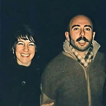 Retrato de un hombre barbudo con bigote y una mujer sonriente con cabello oscuro y flequillo, ambos miran a la cámara contra un fondo oscuro