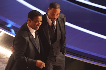 Denzel Washington (L) walks with