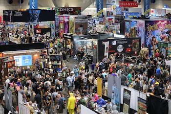 Attendees walk the convention floor,