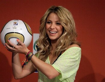 Shakira holds a ball that