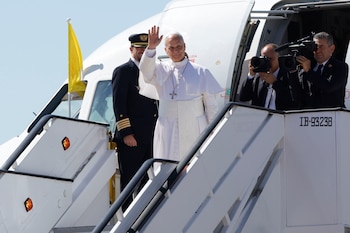 El papa León XIV saluda mientras sube abordo de un avión con destino a Barcelona. (EFE/Zipi)