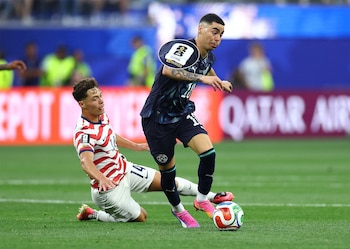 Dos futbolistas, uno de México (camiseta verde, #8) y otro de Sudáfrica (camiseta amarilla, #13), disputan un balón en un campo de fútbol. Un árbitro observa