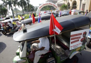 A convoy of Thai three-wheeled