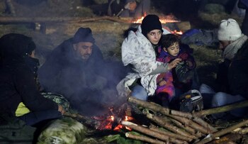 Migrantes sentados alrededor de un