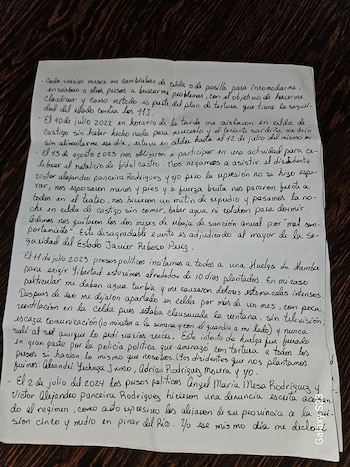 Una hoja de papel con texto manuscrito en tinta negra, doblada y arrugada, colocada sobre una superficie de madera oscura