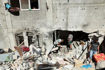 Palestinos inspeccionan el lugar donde