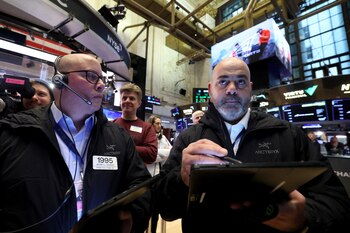 Traders work on the floor