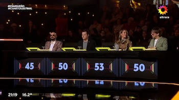 Cuatro personas sentadas en un panel. Las pantallas frontales muestran las puntuaciones 45, 50, 53 y 50. Hay público detrás