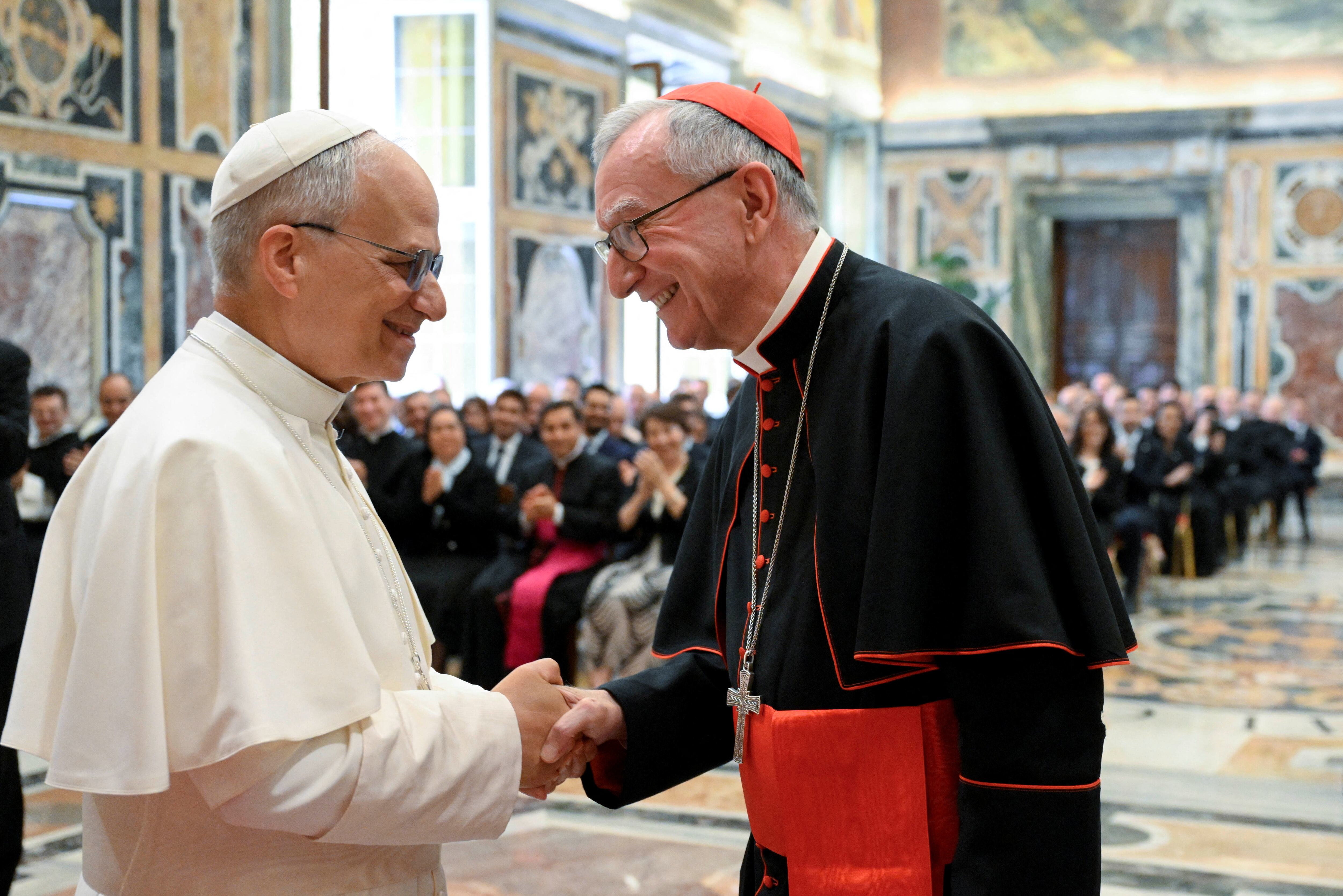Pope Leo XIV shakes hands with Cardinal Pietro Parolin during is his meeting with officials of the Vatican Secretariat of State, at the Vatican, June 5, 2025. Vatican Media/Handout via REUTERS ATTENTION EDITORS - THIS IMAGE WAS PROVIDED BY A THIRD PARTY.