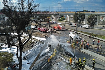 Mexican firefighters extinguish the flames