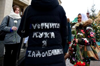A photograph shows a text which reads as "Bring my husband back, I'm tired of it" written on a jacket, as relatives of Russian soldiers take part in the so-called "special military operation" in Ukraine, and gather to lay flowers at the Tomb of the Unknown Soldier in Moscow on December 23, 2023. (Photo by Olga MALTSEVA / AFP)