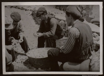 Rancheros con vecinos de Puertomingado (Teruel) pelando patatas para el rancho de la línea próxima de fuego (Biblioteca Nacional de España)