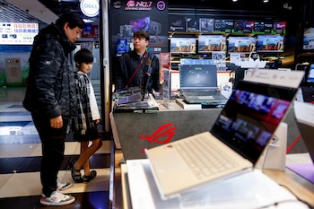 Consumidores en una tienda de electrónica, debatiendo compras ante la expectativa de costos más altos. (REUTERS/Ann Wang)
