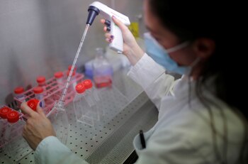 A researcher works on cell culture in a laboratory as part of a project to develop a Covid nasal spray vaccine that could protect against the coronavirus disease (COVID-19), at the University of Tours, France, September 15, 2021. REUTERS/Stephane Mahe