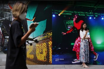 Women look at their phones