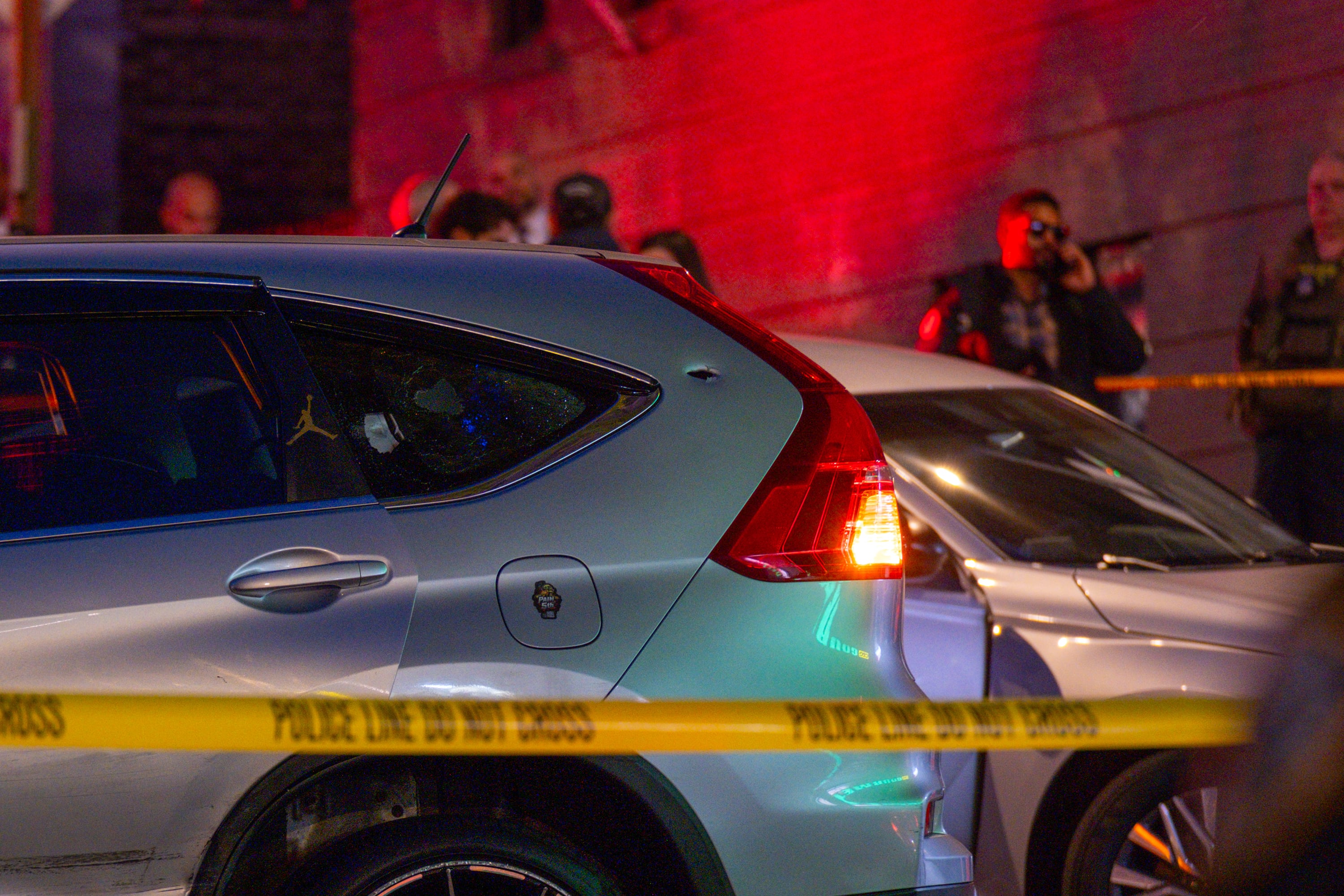 A bullet hole and a shattered window are seen on the car driven by a man who was shot by federal immigration agents in the Marble Hill neighborhood of New York on Thursday night, Oct. 8, 2026. A police spokesman said the person who was shot had been taken to a nearby hospital and was conscious and receiving medical attention. (Dakota Santiago/The New York Times)