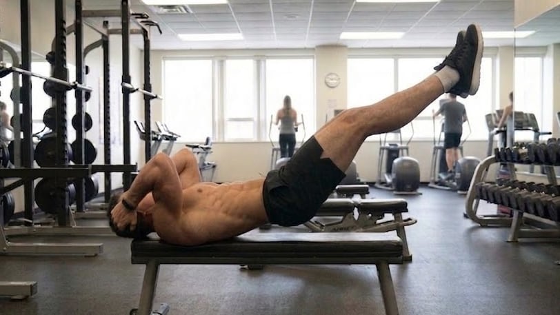 La variante inicial del Dragon Flag permite a los principiantes desarrollar fuerza abdominal elevando solo piernas y cadera para una mayor adaptación (Imagen Ilustrativa Infobae)