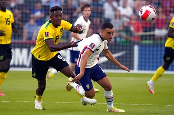 Oct 7, 2021; Austin, Texas, USA; Jamaica forward Jamal Lowe (9) pulls the jersey of United States defender Sergino Dest (2) during the first half of a FIFA World Cup Qualifier at Q2 Stadium. Mandatory Credit: Chuck Burton-USA TODAY Sports