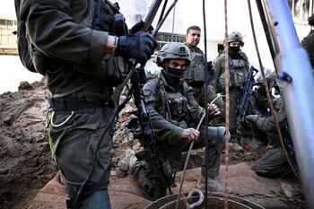 Israeli soldiers use a camera