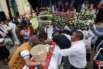 Feligreses y familiares rodean el ataúd con el cuerpo del sacerdote Marcelo Pérez, quien fue asesinado el domingo en San Cristóbal de las Casas después de oficiar una misa, durante una misa fúnebre, en San Andrés Larraínzar, en el estado sureño de Chiapas, México, el 21 de octubre. 2024. REUTERS/Gabriela Sanabria