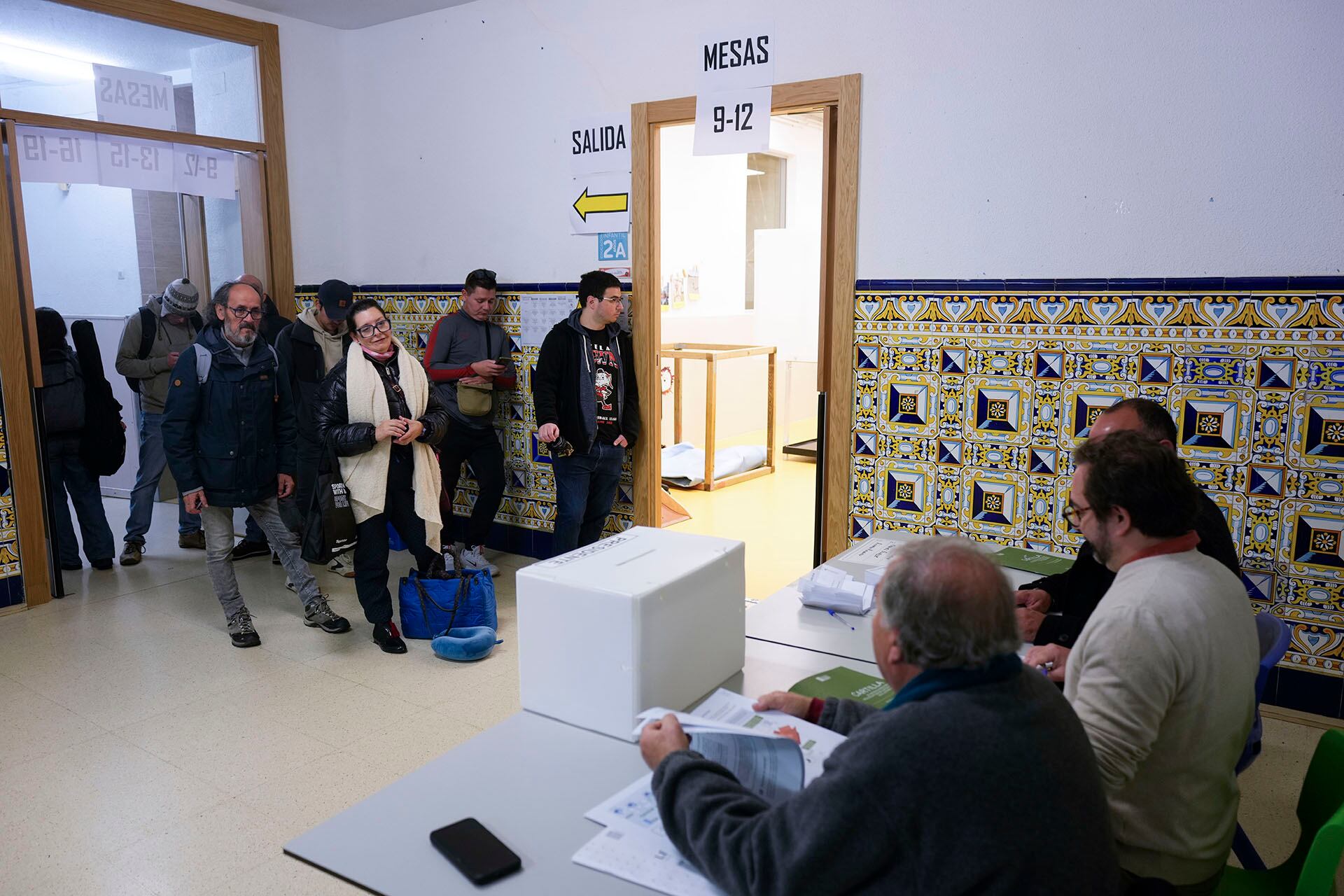Varias personas esperan para depositar su papeleta en el colegio Blanco Castilla de Madrid convertido en colegio electoral (EFE/Borja Sánchez-Trillo)