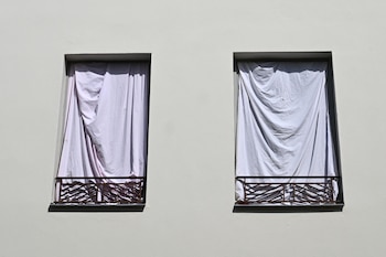 Varias ventanas tapadas con sábanas para intentar evitar la entrada del calor en Francia. (Sebastien Salom-Gomis/AFP)