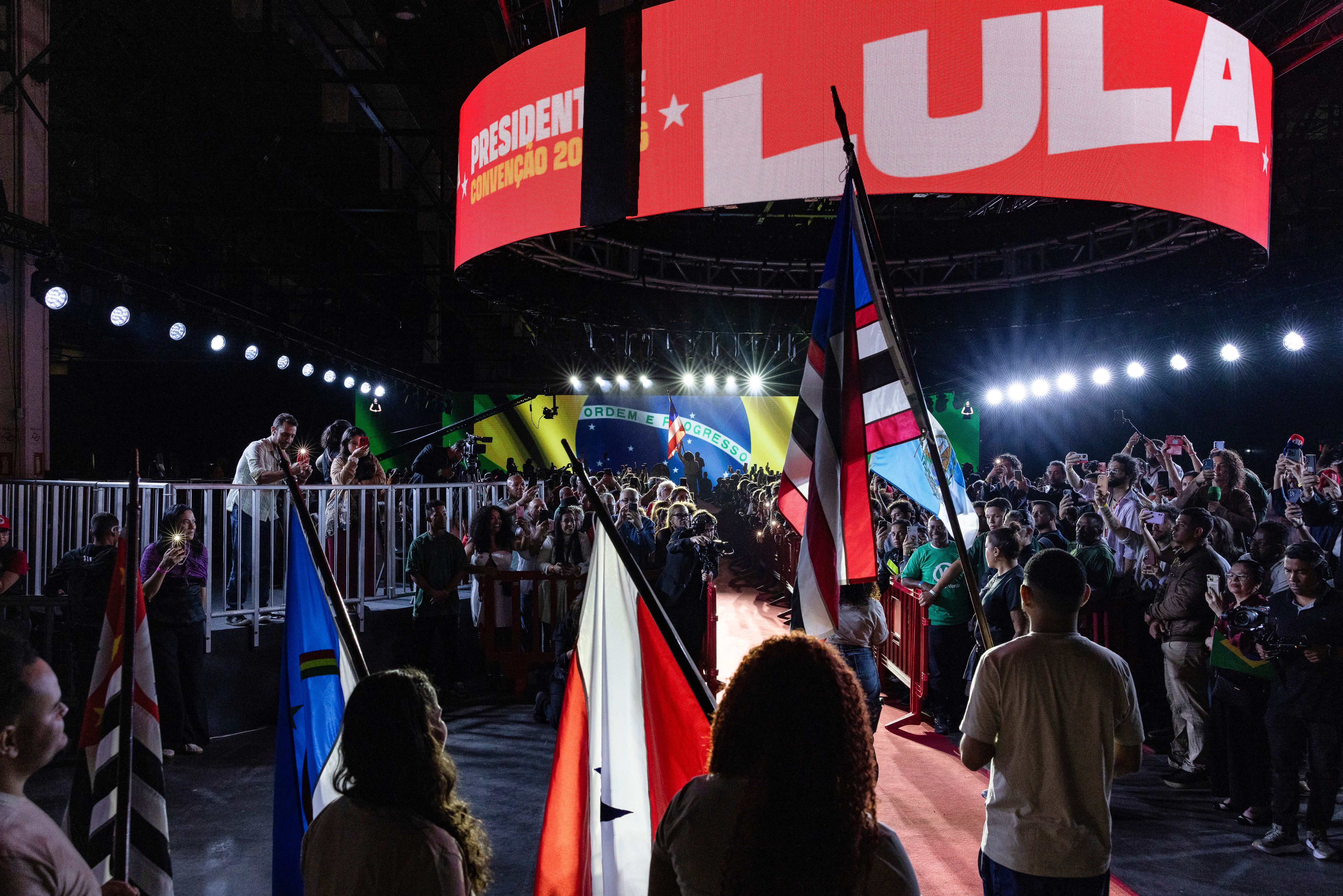 FILE — Attendees hold up their phones during the launch event for President Luiz Inácio Lula da Silva’s presidential reelection campaign in São Paulo, Aug. 2, 2026. Luiz Inácio Lula da Silva, the leftist incumbent, and Flávio Bolsonaro, the right-wing challenger, face off in a race that could define the future of Latin America. (Victor Moriyama/The New York Times)