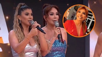 Dos mujeres sostienen micrófonos en un escenario; una tercera mujer sonriente aparece en un círculo con borde naranja en la esquina superior derecha.