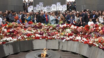 People lay flowers at the