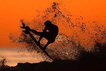 A surfer takes some air
