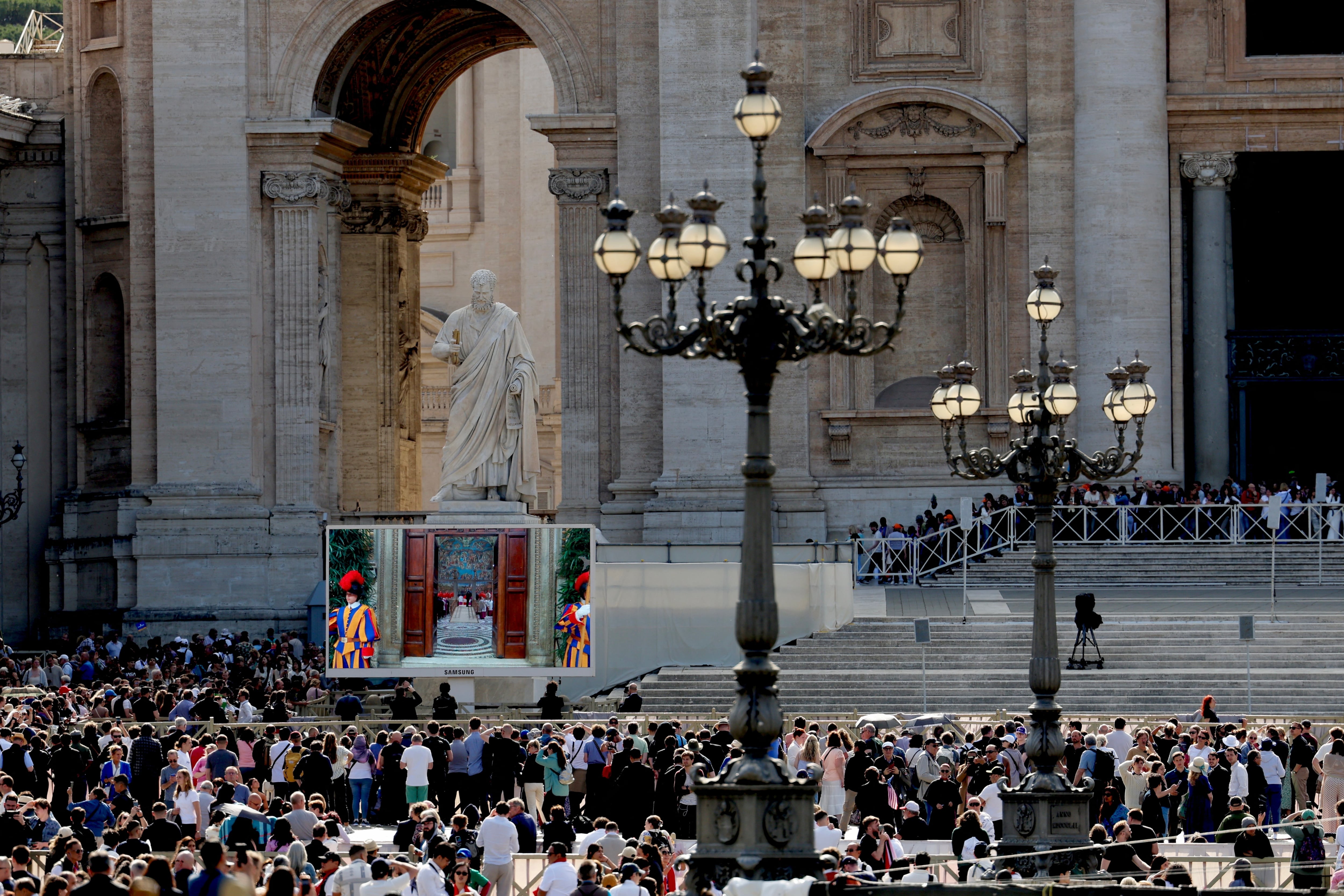 People watch a screen in Saint Peter