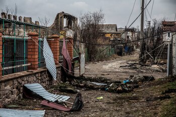 Bodies of Russian soldiers lie among civilian homes on March 30 in the village of Moshchun, Ukraine, where heavy fighting between Russian and Ukrainian forces. MUST CREDIT: Photo for The Washington Post by Heidi Levine.