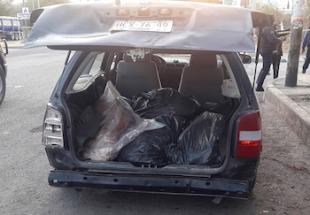SENSITIVE MATERIAL. THIS IMAGE MAY OFFEND OR DISTURB Bags containing human remains are stacked inside a car after the severed heads of six men were discovered atop the car, as police secures the crime scene, in Chilapa, Mexico March 31, 2022. REUTERS/Stringer NO RESALES. NO ARCHIVES