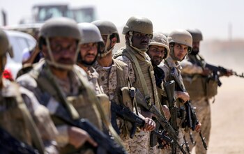 Saudi soldiers stand by in