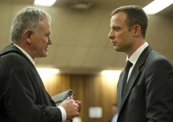 Lawyer Barry Roux (L) speaks with his client, South African paralympic athlete Oscar Pistorius, during a tea break on the fifth day of his trial for the 2013 murder of his girlfriend Reeva Steenkamp, at the high court in Pretoria, on March 7, 2014. Pistorius faces two charges ; murder and contravention of the Firearms Control Act. Pistorius, a double amputee known as the "Blade Runner" for his carbon-fibre running blades, faces 25 years in South Africa's brutal jails and an abrupt end to his glittering sporting career if convicted. AFP PHOTO / POOL / THEANA BREUGEM (Photo credit should read Theana Breugem/AFP/Getty Images)