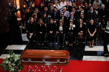 Family members and people sit