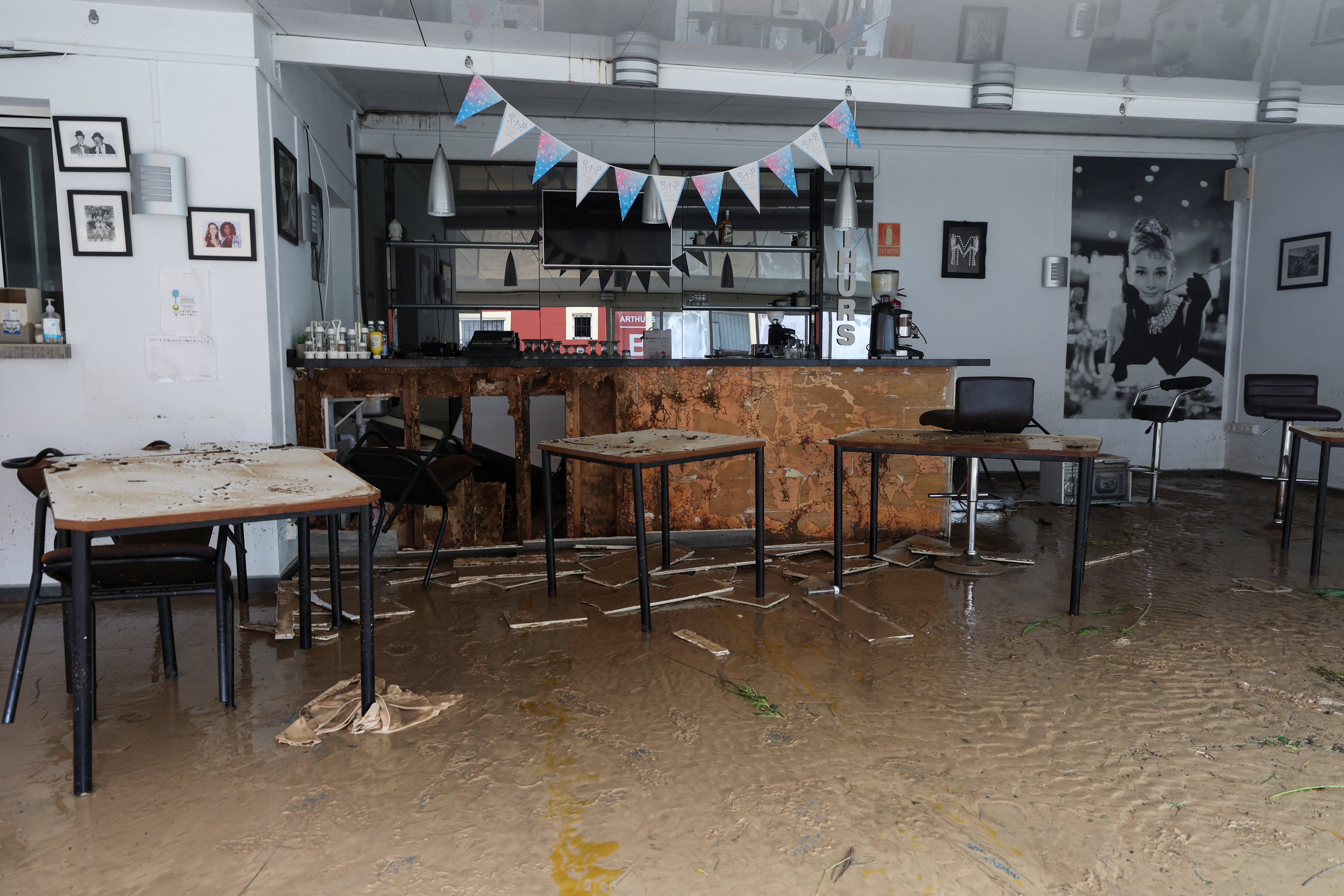 Interior of a venue covered in mud, following torrential rains, which caused floods in eastern Spain, in Els Poblets, Alicante province, Spain, October 19, 2026. REUTERS/Eva Manez