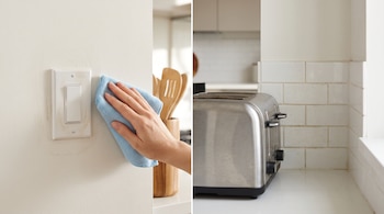 Una mano sostiene un paño azul cerca de un interruptor con grasa y una tostadora se ubica junto a una pared de azulejos.