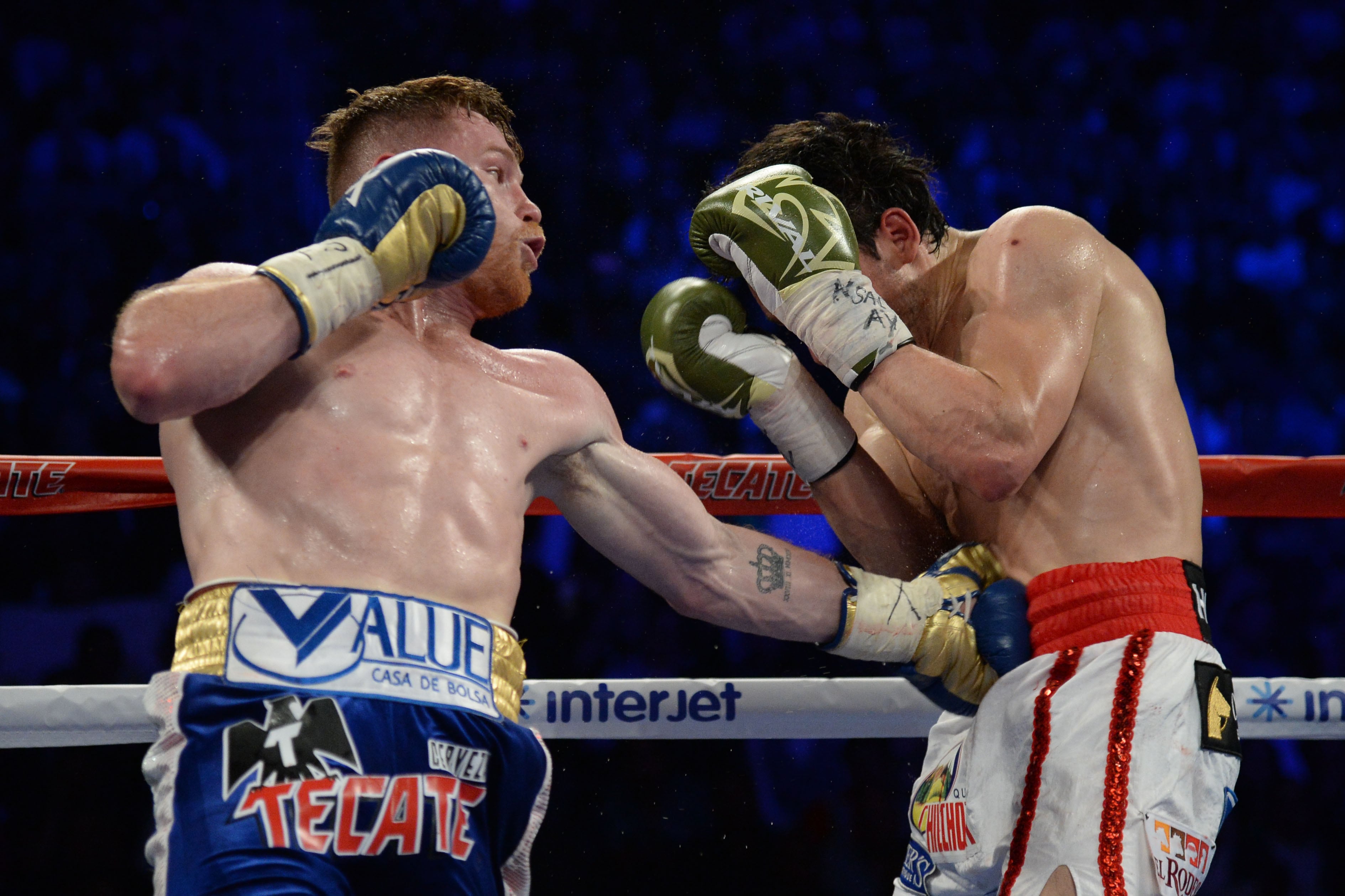 May 6, 2017; Las Vegas, NV, USA; Canelo Alvarez (blue/gold trunks) and Julio Cesar Chavez Jr. (white trunks) box during their bout at T-Mobile Arena. Alvarez won via unanimous decision. Mandatory Credit: Joe Camporeale-USA TODAY Sports